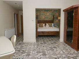 A bedroom with a bed and a table at Lilac Cottage in Grange-Over-Sands