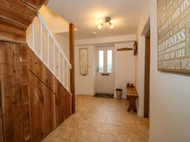 An entrance hall with stairs and a door at 1 Dingle Cottage in Worcester