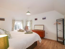 A bedroom with a bed and dressing table at 1 Dingle Cottage Worcester