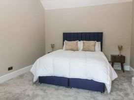 A bedroom with a bed and side table at Fox House in Llandudno