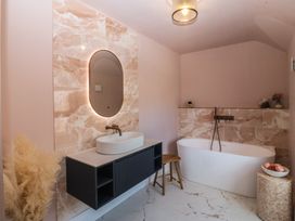 A bathroom with bathtub and vanity unit at Fox House in Llandudno