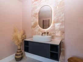A bathroom with a sink and mirror at Fox House in Llandudno