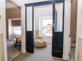 A hallway with a bean bag and a chair at Fox House in Llandudno