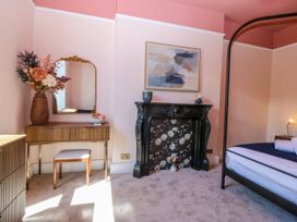 A bedroom with a bed and decorative elements at Fox House in Llandudno