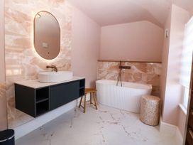 A bathroom with a sink and bathtub at Fox House in Llandudno