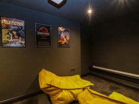 A media room with posters and bean bags at Fox House in Llandudno
