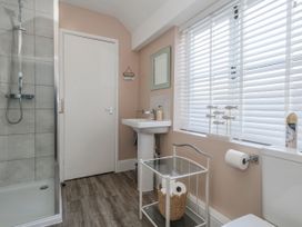 A bathroom with shower and sink at Shrimp Cottage in Brewers Quay Harbour