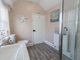 A bathroom with toilet, sink, and shower at Shrimp Cottage in Brewers Quay Harbour