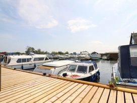 A marina with boats docked at Kingsmere in Norwich