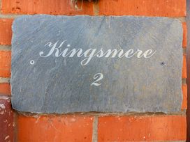A name plaque displaying Kingsmere 2 on a brick wall at Kingsmere in Norwich