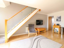 A living room with a staircase and furniture at Kingsmere in Norwich