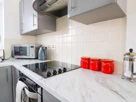 A kitchen with appliances and storage jars at Kingsmere in Norwich