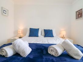 A bedroom with a bed and towels at Kingsmere in Norwich