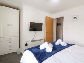 A bedroom with a bed and television at Kingsmere in Norwich