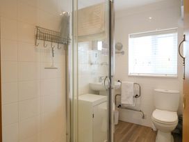 A bathroom with a shower, toilet, and sink at Kingsmere in Norwich