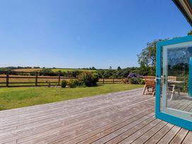 An outdoor area with decking and furniture at Little Chywoon Barn in Truro