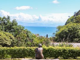 A sculpture viewed from behind overlooking the sea at 3 Glyn Y Mor Llanbedrog