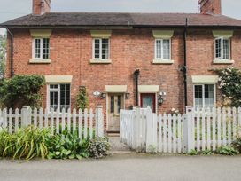 A house with a white fence and plants at 2 Aqueduct Cottages Chirk Bank near Chirk