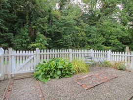 A garden with a fence, gate, table and chairs at 2 Aqueduct Cottages Chirk Bank near Chirk