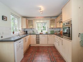 A kitchen with appliances and cabinetry at 2 Aqueduct Cottages in Chirk Bank near Chirk