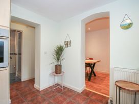 A kitchen with a plant and a dining area at 2 Aqueduct Cottages Chirk Bank near Chirk