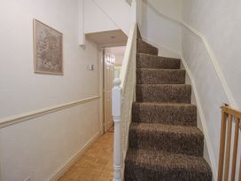 A hallway with stairs and a framed picture at 2 Aqueduct Cottages Chirk Bank near Chirk