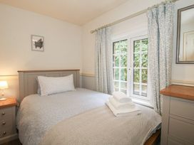 A bedroom with a bed and dresser at 2 Aqueduct Cottages Chirk Bank near Chirk