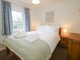 A bedroom with a bed and towels at 2 Aqueduct Cottages Chirk Bank near Chirk
