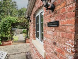 A brick exterior with a window and lanterns at 2 Aqueduct Cottages in Chirk Bank near Chirk