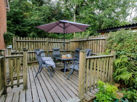 An outdoor seating area with a table and chairs at 2 Aqueduct Cottages Chirk Bank near Chirk