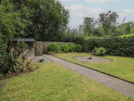 A garden with a pathway and a shed at 2 Aqueduct Cottages Chirk Bank near Chirk