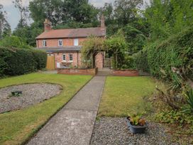 A garden with a pathway leading to a house at 2 Aqueduct Cottages Chirk Bank near Chirk