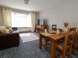 A living room with a dining area and a television at Lily's Pad Weston, Portland