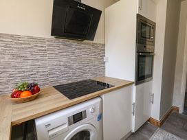 A kitchen with a washing machine and built-in appliances at Lily's Pad in Weston, Portland
