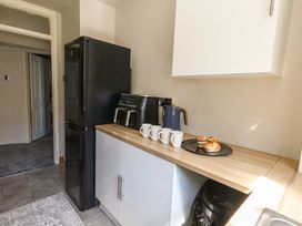 A kitchen with a refrigerator, coffee maker, and pastries at Lily's Pad in Weston, Portland