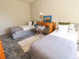 A bedroom with two beds and a desk at Lily's Pad in Weston, Portland