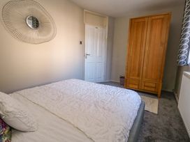 A bedroom with a bed and wardrobe at Lily's Pad in Weston, Portland