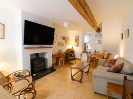 A living room with a fireplace and a television at No.23 Queen St in Aberystwyth