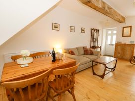 A living room with a sofa and dining table at No.23 Queen St Aberystwyth
