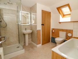 A bathroom with a shower, toilet, sink, and bathtub at No.23 Queen St in Aberystwyth