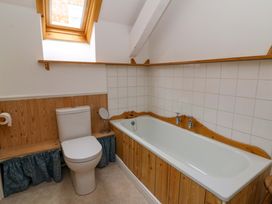A bathroom with a bathtub and toilet at No.23 Queen St in Aberystwyth