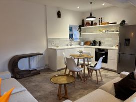 A kitchen with a dining table and chairs at Bracken Cottage