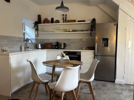 A kitchen with a table and chairs at Bracken Cottage in 