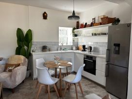 A kitchen with a dining table and chairs at Bracken Cottage in Osmington