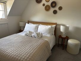 A bedroom with a bed and bedside tables at Bracken Cottage in Osmington