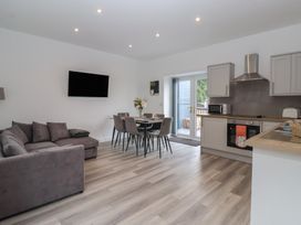 A living room with a sofa and dining area at Birch Cottage in Scarborough