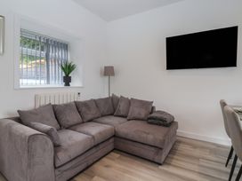A living room with a sofa and television at Birch Cottage in Scarborough
