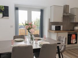 A dining area with a table and chairs at Birch Cottage in Scarborough