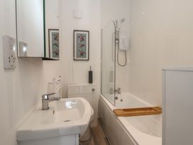A bathroom with a bath and shower at Birch Cottage in Scarborough