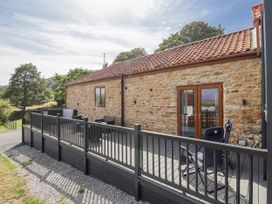 A property with decking and chairs at Birch Cottage in Scarborough